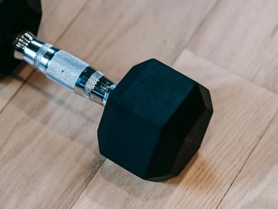 Dumbbells and weights on a dark textured floor